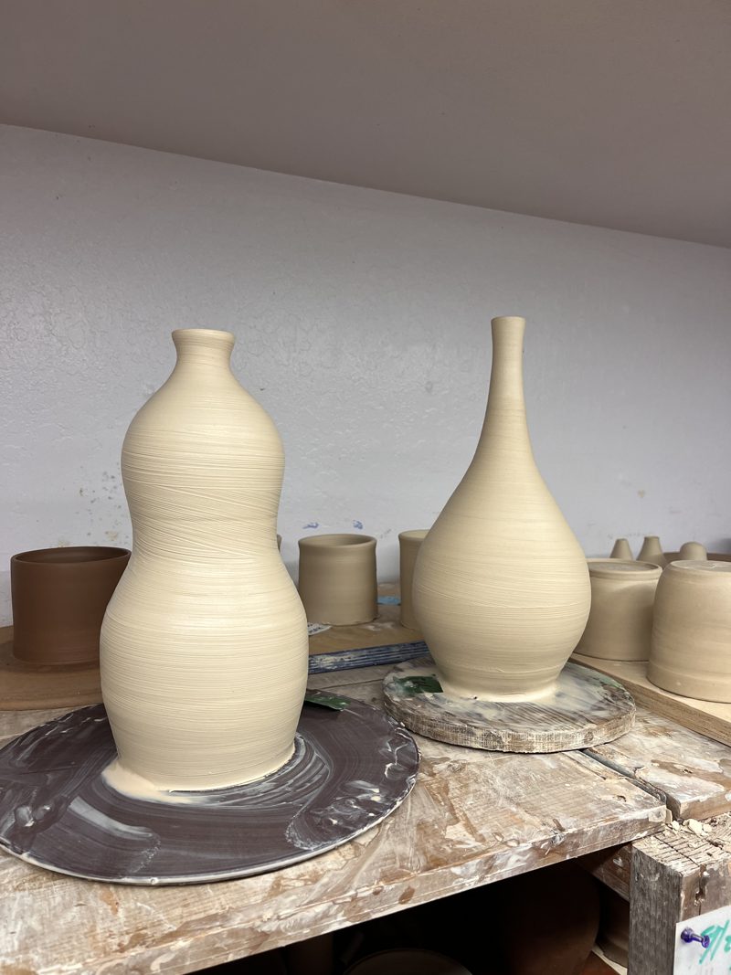 Two bottles, freshly thrown, beside the wheel.