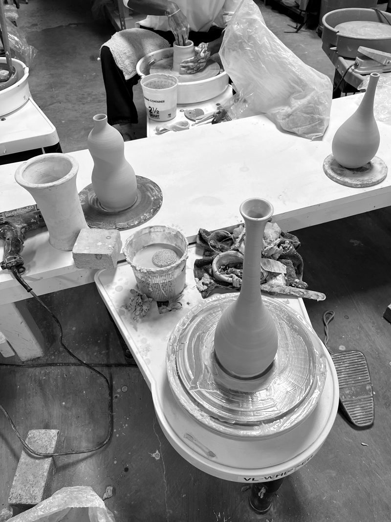 A tall bottle on the wheel at the end of a throw.